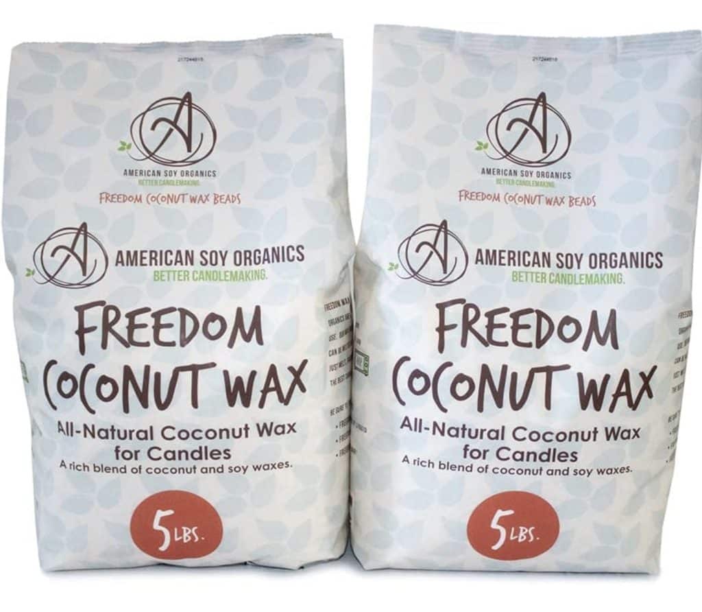 Two bags of American Soy Organics Freedom Coconut Wax for candles with dried flowers are shown. Each bag weighs 5 lbs and features a decorative background adorned with logos and text highlighting its all-natural coconut wax blend.